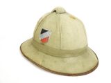 an old helmet with a flag on it sitting on a white surface