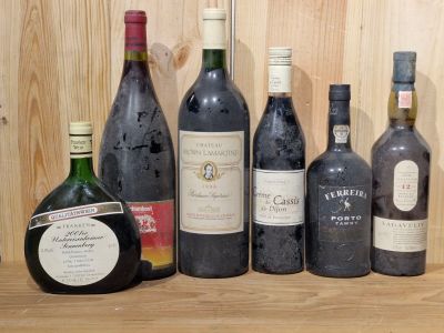several bottles of wine are lined up on a wooden shelf