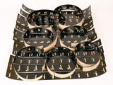a lot of black and white plates and bowls on a table