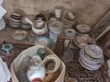many plates and bowls on the floor in this room