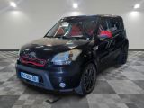 a picture of a small black car parked in a garage