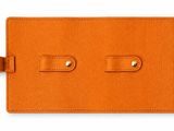 a close up of an orange luggage tag on a white background