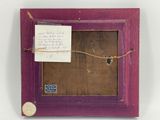 an old picture frame with a piece of paper attached to it