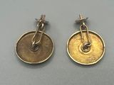 two pairs of gold earrings with a clasp on each ear