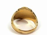 a close up of a gold ring on a white surface