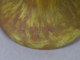 a yellow vase sitting on a table with a white table cloth