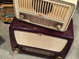 two old radio ' s stacked on top of each other