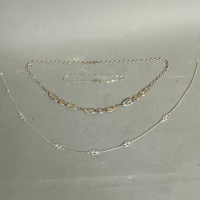 several different types of necklaces and bracelets on a table