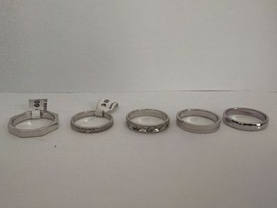 several different types of wedding rings sitting on a white surface