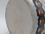 a close up of a vase on a white surface