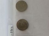 four coins in a plastic container with labels on them