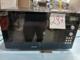 a microwave with a price tag on it sitting on a counter