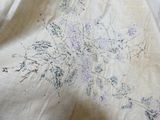an image of a close up of a bed with a floral design on it