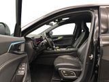 the interior of a car with the door open and the driver ' s seat down
