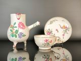 a tea pot and a tea cup sitting on a table