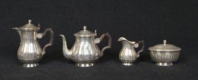 four pieces of silver tea and coffee set on a black background