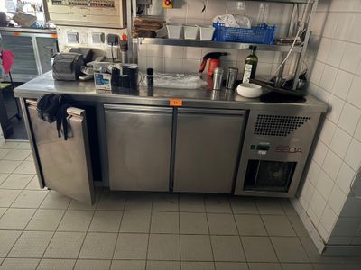 a stainless steel counter in a kitchen with a lot of dishes on it