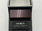 an image of a flash camera mounted on a white surface
