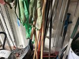 a pile of brooms and other tools in a garage