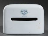 a white tissue dispenser sitting on a table