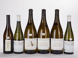 six bottles of wine are lined up in a row on a white surface