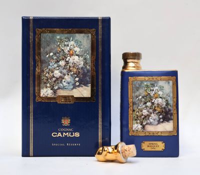 an image of a bottle of perfume next to a box of flowers