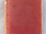 an old wooden frame with a red and gold design