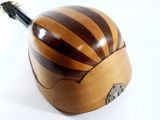a wooden box with a guitar in it on a white surface