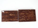 two pieces of chocolate sitting on top of each other on a white surface