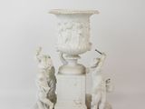 marble urn with cherubs and cherubs on a pedestal