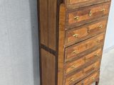 an image of a wooden chest of drawers with marble top