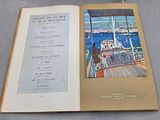 an open book with a picture of a boat in the water