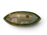 a glass bowl with a label on it on a white surface