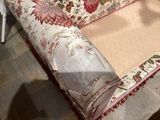 a couch with a floral design on it in a room