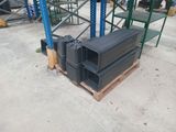 a pile of black plastic boxes on a pallet