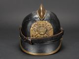 an old helmet with a gold emblem on the top