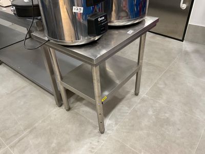 two large pots sitting on a table in the kitchen