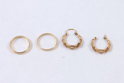 three pairs of gold hoop earrings and a pair of gold hoop earrings