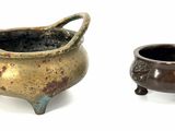 two pots sitting next to each other on a white surface
