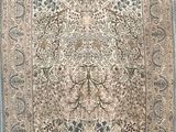an antique persian rug with a floral design on a blue background