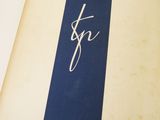 an old book with a blue and white stripe on the cover