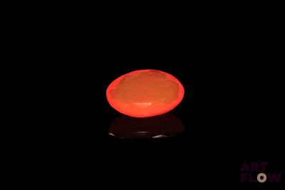 a lit candle in the dark with a black background