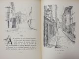 an open book with a drawing of a street in it