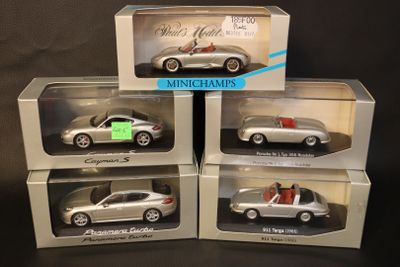 three boxed silver model cars in boxes on a black background