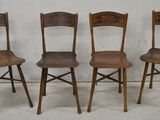 three wooden chairs sitting next to each other on a cement floor