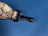 a keychain that has a snake skin pattern on it