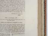 an open book on a white table with a black and white picture