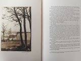 an open book with a picture of a house in the background