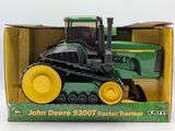 a toy tractor in a box on a white surface