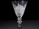 a wine glass that has a picture of a castle on it